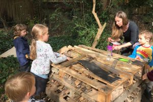 Children stocking a bug hotel